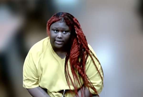 A person in a yellow top leans forward slightly while looking toward the camera.